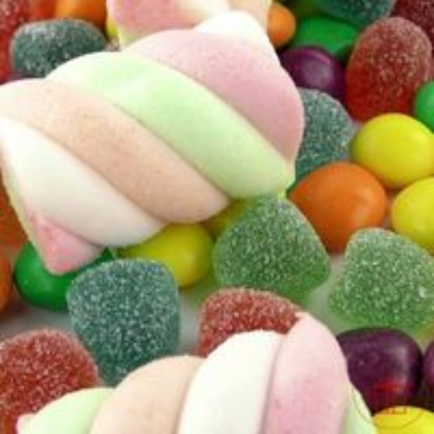 Assorted colorful candies including gummy bears and marshmallows.