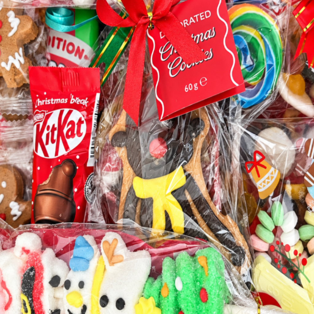 A Christmas-themed candy gift box filled with assorted sweets, lollipops, gingerbread cookies, and festive treats, colourful holiday treats.
