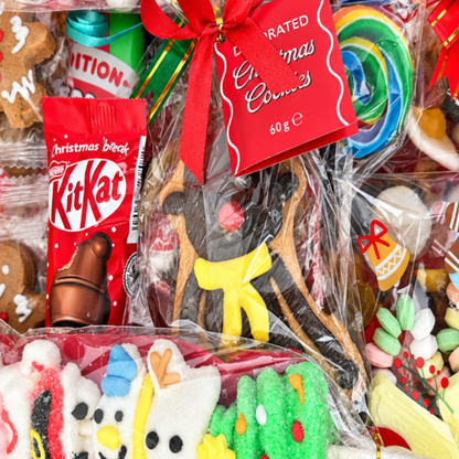 A Christmas-themed candy gift box filled with assorted sweets, lollipops, gingerbread cookies, and festive treats, colourful holiday treats.