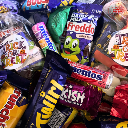Assorted Halloween candy bars including Freddo, Mentos, Twix, and KitKat.